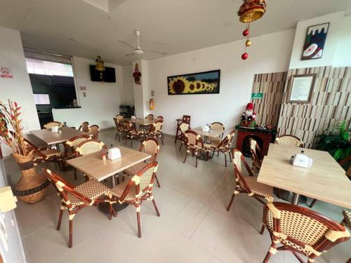 a restaurant with wooden tables and chairs and a fireplace at Hotel Suite Royal in Melgar
