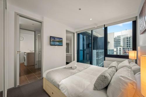 Ένα ή περισσότερα κρεβάτια σε δωμάτιο στο City Stays - Plus