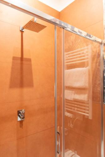 a shower with a glass door in a bathroom at Adelaide Suite Dreams in Rome