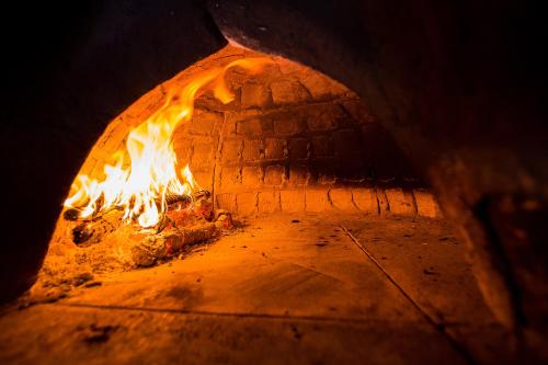 a brick oven with a fire in it at Piedra de Agua Merida in Mérida