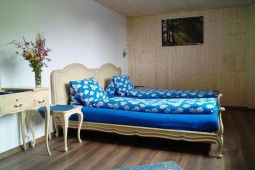 a couch in a room with a table and a desk at Ferienwohnung, Ferienhof Wald in Goldingen