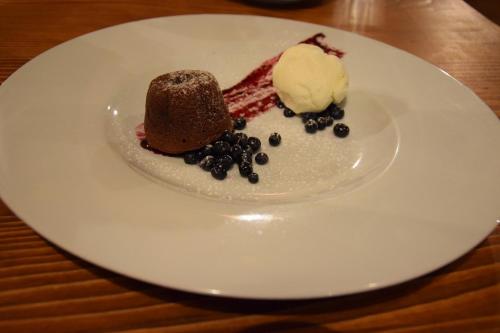 a white plate with a chocolate dessert and ice cream at Apartment U Lipna Nová Pec in Nová Pec