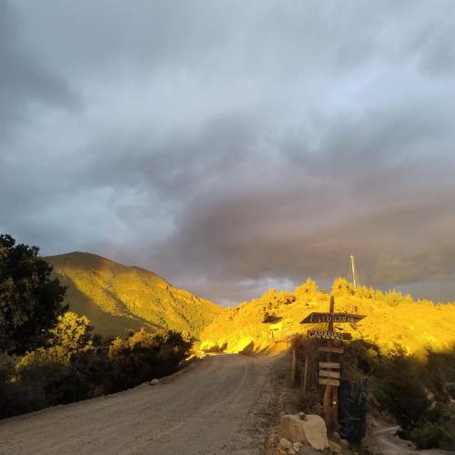 a dirt road in the middle of a mountain at La Polcura Lodge Turismo -Fishing Lodge & Spa in El Llano