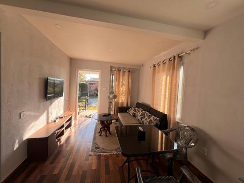 a living room with a couch and a table at Avocado Accommodations in Khadkagaon