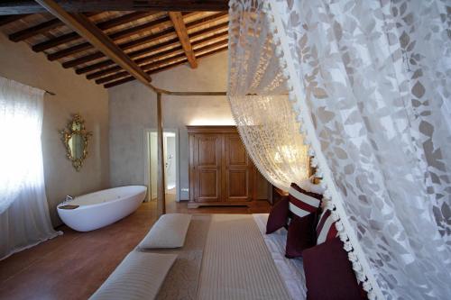 a bathroom with a bath tub and a curtain at Villa Della Torre in Fumane