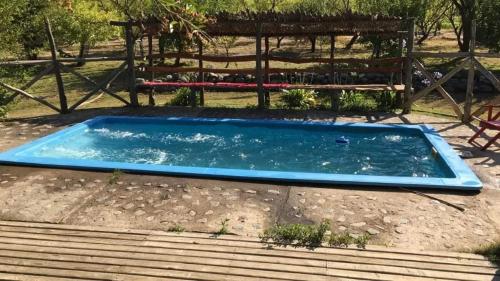 a swimming pool in the ground with a bench at La Polcura Lodge Turismo -Fishing Lodge & Spa in El Llano