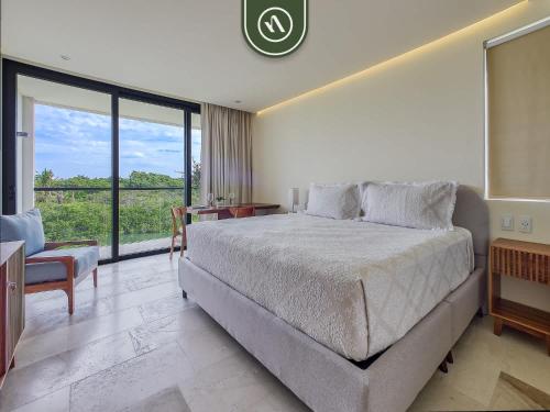 a bedroom with a large bed and a large window at Luxury Condo with Canal View - Near Beach in Nuevo Vallarta 