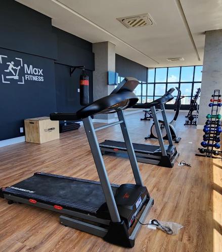 a gym with three treadmills in a room at Max Derby - Studios no Centro do Recife por Yolo in Recife