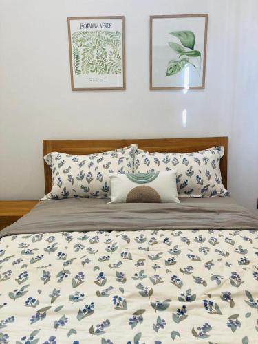a bed with blue and white sheets and pillows at Oceana Residence 2 in Mont Choisy