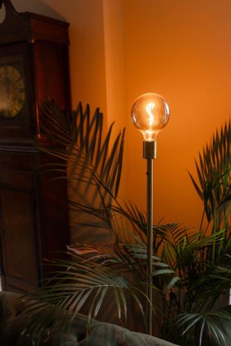 a light pole in a room with a clock at Hof van Slenaken - Hotel & Apartments in Slenaken