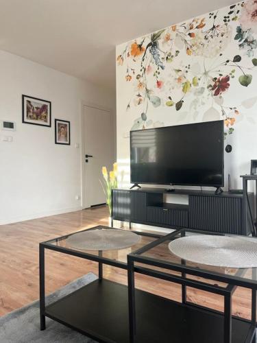 a living room with a flat screen tv on a wall at Apartament Andrea in Oleśnica