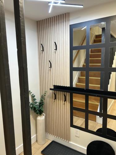 a room with a staircase and a mirror at Luxurious modern basement apartment in Pickering