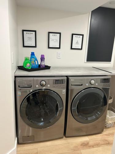 a laundry room with a washer and dryer at Luxurious modern basement apartment in Pickering
