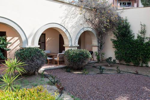a courtyard with a table and chairs in a building at Aphrodite Premium Apartments I in Kouklia