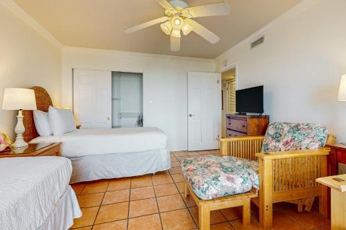 a hotel room with two beds and a tv at Ocean Vista #1101 in South Padre Island