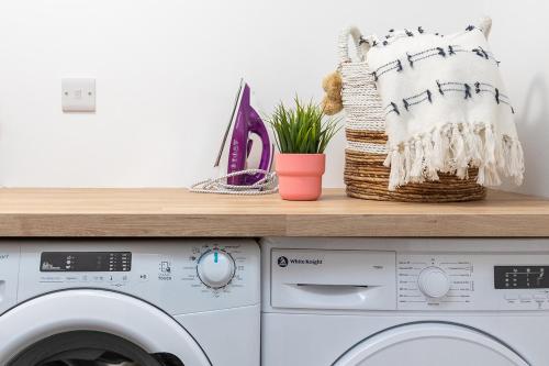a laundry room with a washer and dryer at Luxury Lower-Level One Bed Apt in Headingley