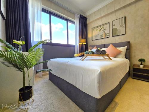 a bedroom with a bed with a large window at Loft Suite Central City 2BR JB CIQ 7Pax in Johor Bahru