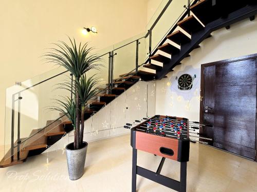 a potted plant in a room with stairs at Loft Suite Central City 2BR JB CIQ 7Pax in Johor Bahru