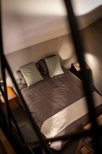 a person sleeping on a bed in a room at Studio Kittel Guest Room with Private Bathroom in Bruges