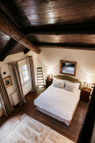 a bedroom with a large bed and a wooden ceiling at Residenza San Vito in Calamandrana
