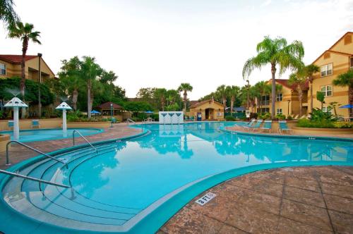 a large swimming pool at a resort with palm trees at Blue Tree Resort at Lake Buena Vista in Orlando