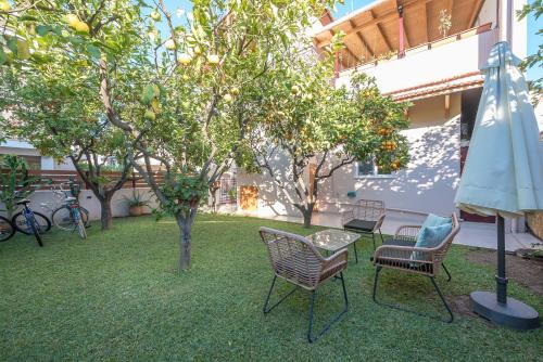 a patio with chairs and a table and an umbrella at In the center of Messolonghi in Mesolongion