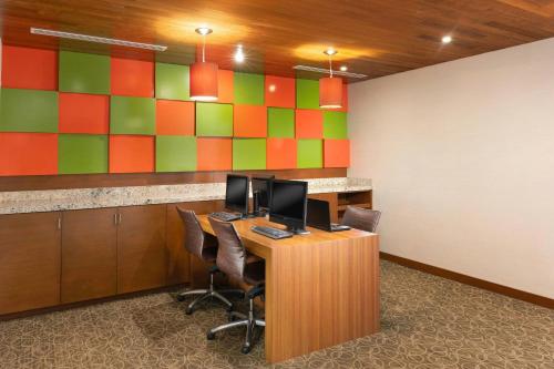 an office with a desk with two computer monitors on it at Courtyard by Marriott La Paz Baja California Sur in La Paz