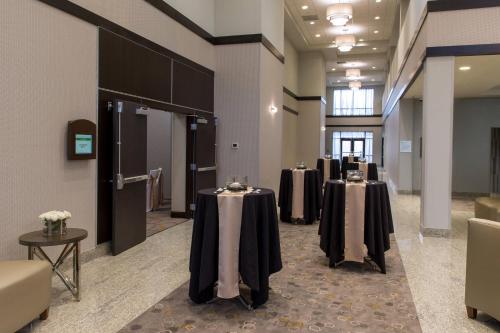 a row of tables with black and white table cloths at Courtyard by Marriott Lafayette in Lafayette