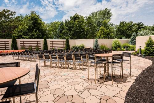 a patio with tables and chairs in a yard at Courtyard by Marriott Lafayette in Lafayette