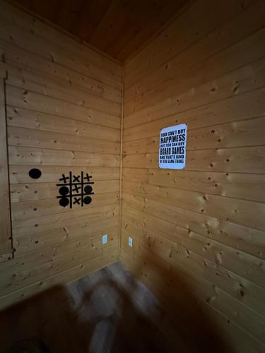 a room with a sign on a wooden wall at Large Cabin Perfect for families in Sevierville