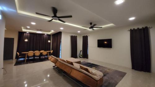 a living room with a couch and a table at Sastred villa Mus'lim Only in Sungai Petani