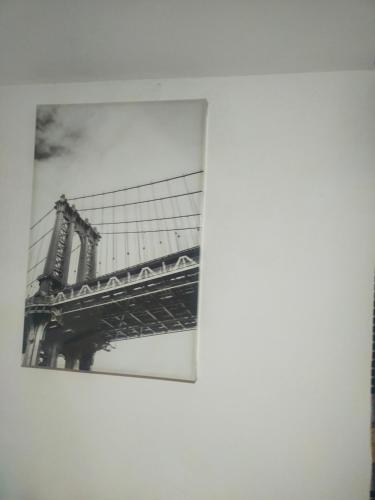 a picture of the brooklyn bridge reflecting in a building at B&B S'arenada in Ghilarza