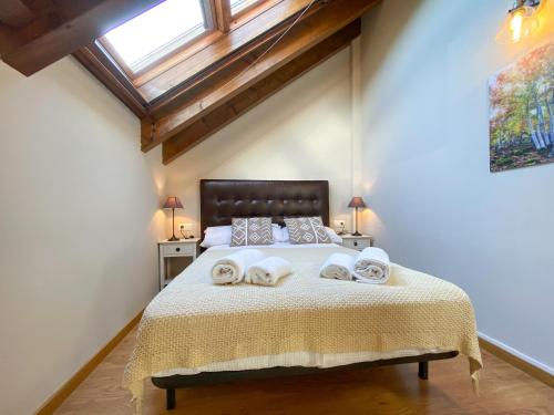 a bedroom with a large bed with towels on it at Potxó Rural in Tirvia