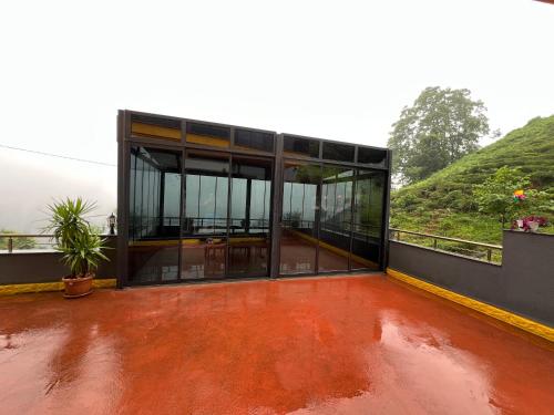 a house with glass doors and a red floor at Çolakoglu konagı in Cayeli