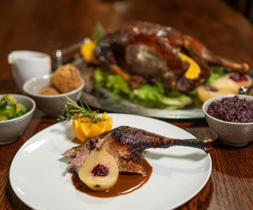 a table with two plates of food with a turkey at Hof Bissee Nature Hideaway Guesthouse "Corn Barn" in Bissee