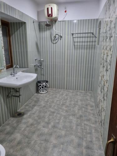 a bathroom with a sink and a mirror at Harsh Villa in Prayagraj