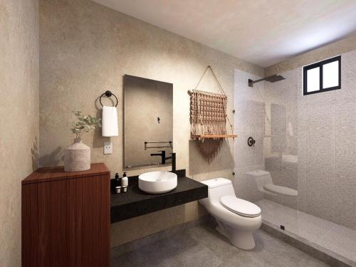カンクンにあるCondo in the perfect spot at downtown Cancunのトイレ、洗面台、浴槽を備えたバスルーム