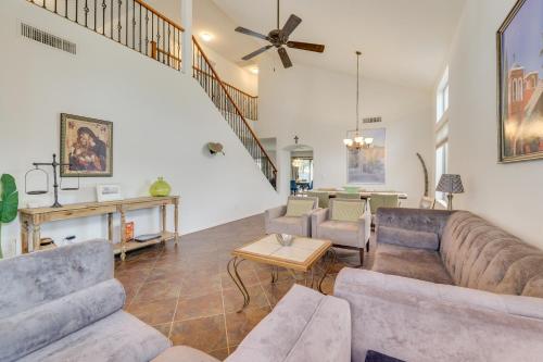 a living room with a couch and a table at Large Pool and Yard with Bocce Oasis in Coolidge! in Coolidge