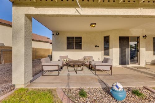 a patio with chairs and a table on a patio at Large Pool and Yard with Bocce Oasis in Coolidge! in Coolidge