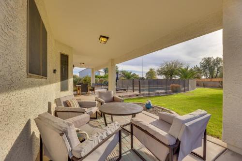 a patio with couches and a table and chairs at Large Pool and Yard with Bocce Oasis in Coolidge! in Coolidge