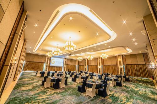 a large banquet hall with tables and chairs in it at Gift City Club, a member of Radisson Individuals in Gandhinagar