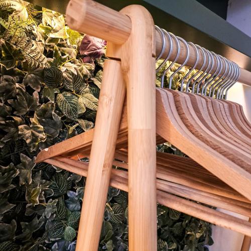 a wooden bench next to a bunch of plants at Chambre et salle de bain privative in Liège