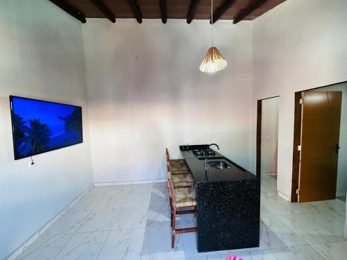 Vila Limeira في بورتو سيغورو: مطبخ مع موقد وطاولة في الغرفة