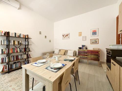 a dining room with a table and a couch at Two-room apartment in Segrate - Comfort, 10 minutes from Milano, Cortina 2026 Winter Olympics in Segrate