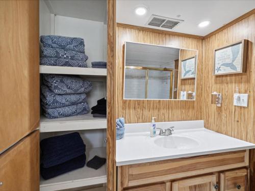 a bathroom with a sink and a mirror and towels at The Hideaway at Weeki Wachee in Weeki Wachee