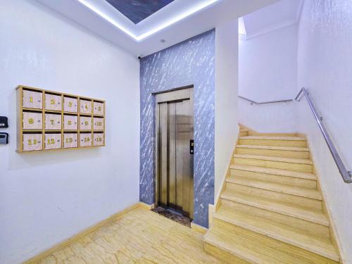 a hallway with stairs and a door in a building at Elite Holiday Home - Luxury & Centric Flat in Tangier