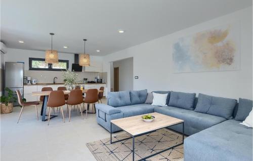 a living room with a blue couch and a table at Villa My Hana in Pula