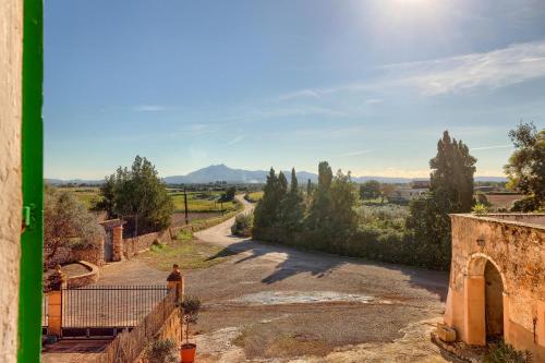 an empty road with a mountain in the distance at Agroturismo Finca Son Valls - Adults Only in Felanitx