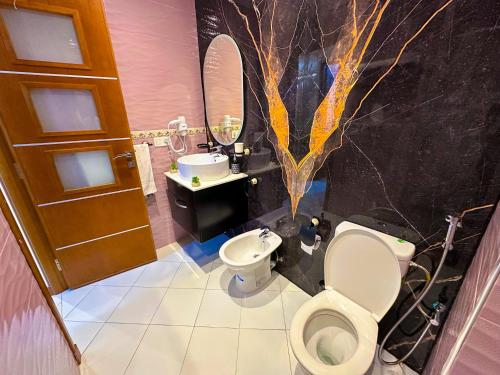 a bathroom with a toilet and a sink at Elite Holiday Home - Luxury & Centric Flat in Tangier