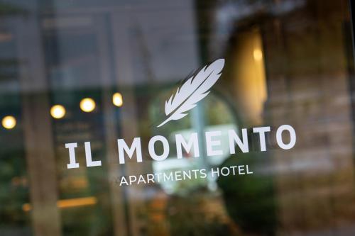 a window with the l monnero logo on it at Aparthotel Il Momento Bern Expo - Self Check-In Hotel in Bern